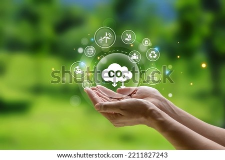 Sustainable development and green business based on renewable energy, CO2 emission in hand of human for environment. Royalty-Free Stock Photo #2211827243