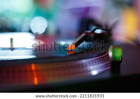 Turntables needle on vinyl record. Listen to music in hi fi quality. Professonal disc jockey turn table player. Download stock photo of disk jokey turntable for poster design