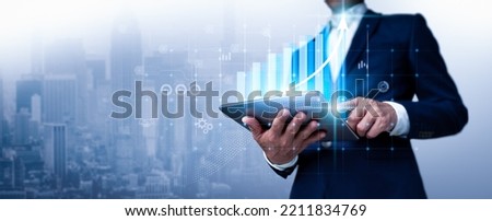 A businessman looks over sales figures and a 3D graph of economic growth. This is a business plan. The abstract icon. The usage of digital marketing is referred to as