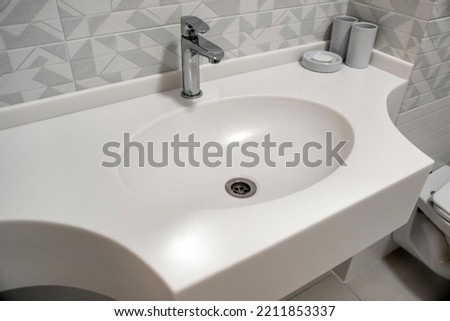 White ceramic sink in a modern bathroom interior