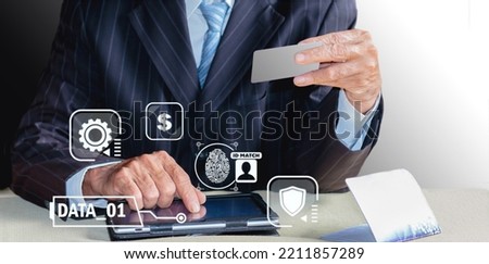 Close-up of business man protecting credit card information with digital tablet.