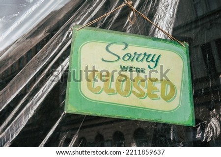 Sign in the shop window behind a pane of glass saying 'Sorry we're closed'. the shop is closed. end of business. closure of business. modern font. Renovation renovation work