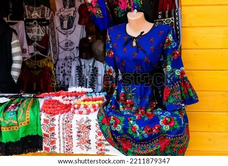 Street store with traditional Romanian clothes in Pitesti, Romania. Tourist souvenir shop. Royalty-Free Stock Photo #2211879347