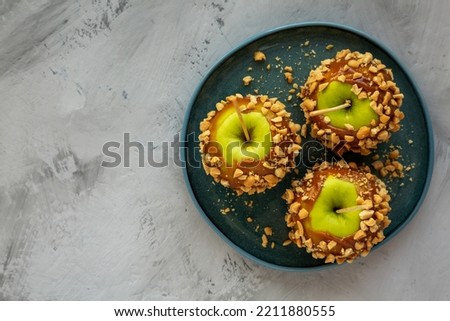 Homemade Halloween Candy Taffy Apples on a Plate, top view. Flat lay, overhead, from above. Space for text. Royalty-Free Stock Photo #2211880555