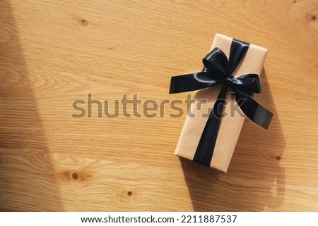  gift box with black thread on a wooden background. Packaging and preparation of gifts for the celebration. Christmas, New Year or birthday backdrop. Place for text