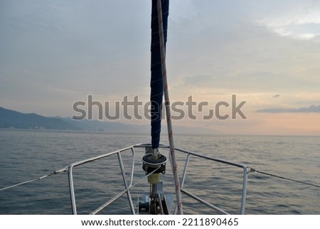 This is a landscape picture of an ocean sunset from a sailboat.