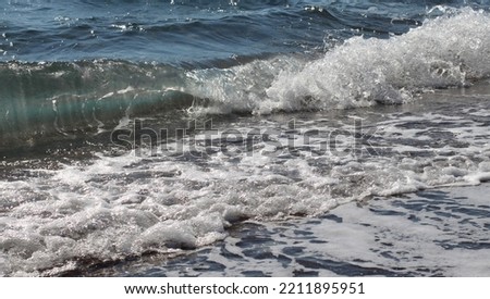 evening photo of the wavy and foamy sea, the foamy waves on the seashore, the last light of the sun and moonlight reflecting on the sea
