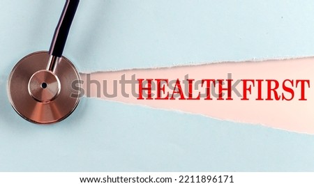 HEALTH FIRST word made on a torn paper, medical concept background