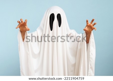 Child dressed up in white costume of scary ghost for Halloween Royalty-Free Stock Photo #2211904759