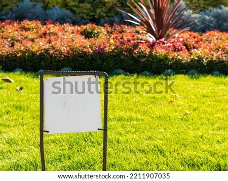 Landscaped Garden with a Blank Sign Ready for Custom Graphics, Logos, Icons or Text