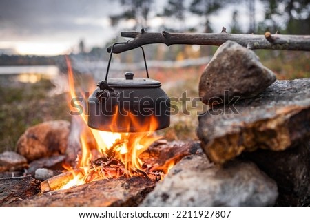 Coffe pot on campfire, Lappland, Finnland, Northen Europe Royalty-Free Stock Photo #2211927807