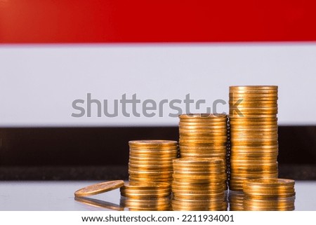 A stack of gold coins on the background of the flag of 
Yemen . Country economy concept