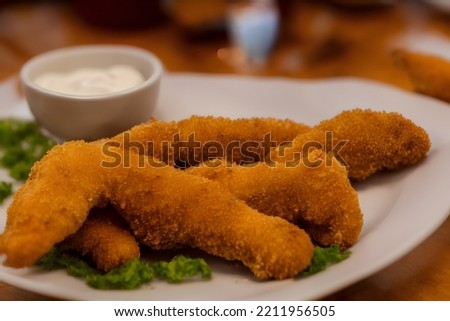 picture of chicken tenders, made of processed meat, a tasty fast food, savory