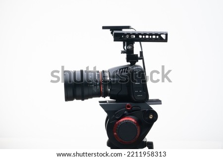 Digital Cinema Camera on a Tripod with an 35mm F1.4 Wide Angle Cine Lens white background 4k