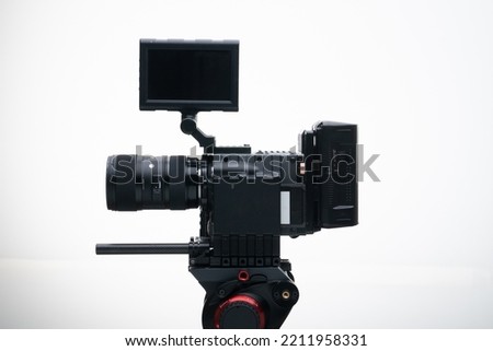 4k Digital Cinema Camera on a Tripod with a 18-35mm F1.8 Zoom Lens Compact white background