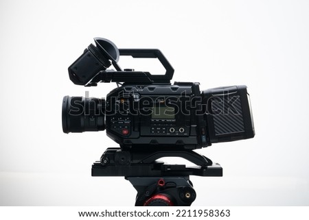 4.6k Digital Cinema Camera on a Tripod with a 50mm F1.4 Prime Lens Viewfinder top handle Compact white background