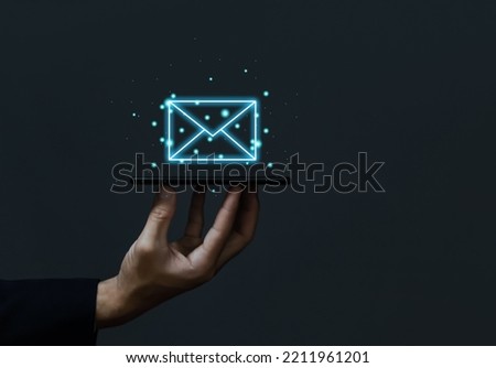 Businessman holding mail icon. Electronic mail concept, online communication on the internet network, receiving and sending of data or messages in digital technology. from a smartphone or computer