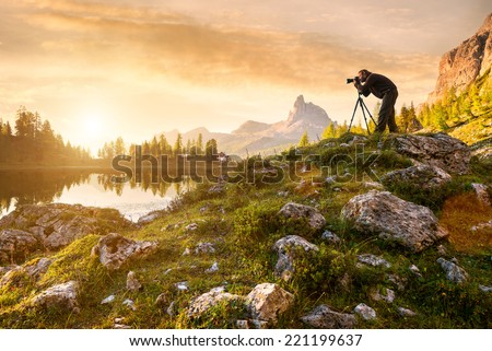 A photographer in the beautiful lake Federa