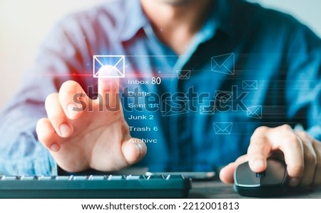 Businessman hand using Computer with email icon, Email typing on keyboard and surfing the internet, email marketing concept, sending e-mail or newsletters, online working internet network.