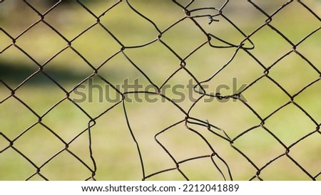 a torn metal mesh, in the photo a metal mesh on a green background.