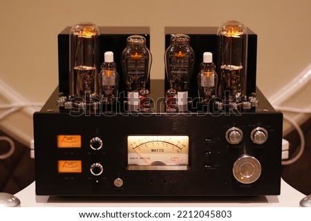 Vacuum tube stereo amplifier. Hi end power amplifier with glowing bulb diode lamp for sound reproduction, Natural sound concept, Electronic vacuum tube or glowing tubes in antique radio                Royalty-Free Stock Photo #2212045803