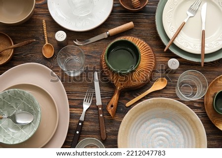 Many different tableware on wooden background, top view Royalty-Free Stock Photo #2212047783