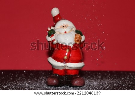 Christmas Santa figurine made from recyclable materials. This image was taken on a red background with some specific elements as well