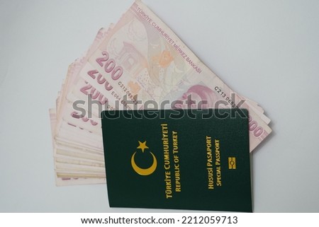 passport with Turkey and Turkish currency and passport with a Turkish Lira (TL) on it, on white paper background