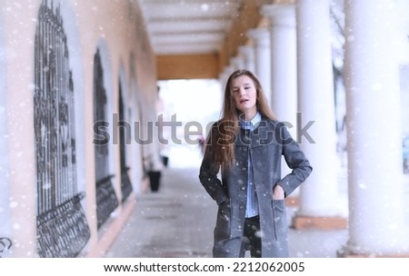 Young girl outdoors in winter. Model girl posing outdoors on a winter day. Festive weekend in the street walking girl.
