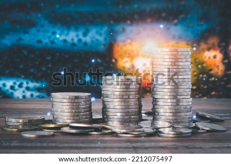 Coins with a money-saving concept and a profit graph of corporate finance in a piggy bank with money boxes for future tourist, house, and retirement funds on a blurred background.