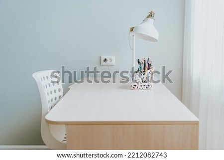Student desk. Desktop organizer with school stationary and office supplies over gray background. Back to school, home office, begining of studies concept