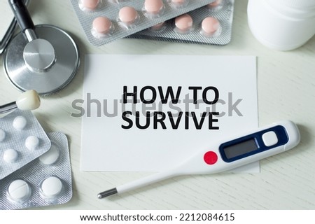 HOW TO SURVIVE text on a card on a table next to a stethoscope and thermometer, tablets