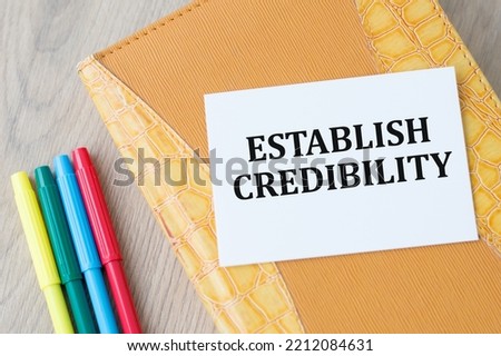 ESTABLISH CREDIBILITY text on an open notebook