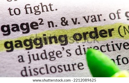 Close up photo of the words gagging order in a dictionary book Royalty-Free Stock Photo #2212089625