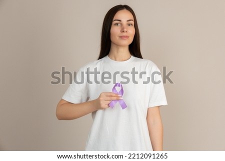 Woman holding a purple ribbon in her hands ADD,ADHD,Alzheimer Disease ,Arnold Chiari Malformation,Childhood Hemiplegia stroke, Epilepsy, Chronic Acute Pain,Crohns Royalty-Free Stock Photo #2212091265