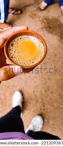 selective focus picture of a hand holding a cup of tea