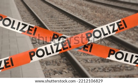 Barrier tape on railway station with the German word POLIZEI (police)