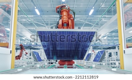 Orange Industrial Robot Arm Grabs and Moves Solar Panels on Conveyor. Automated Manufacturing Facilit. Production Line at Modern Bright Factory. 