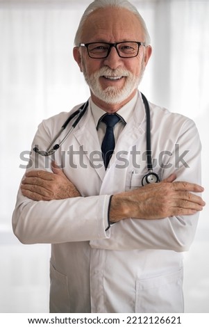 Picture of professional medical worker wearing glasses and stethoscope, smiling for the camera.