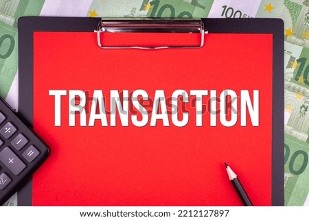 TRANSACTION - word on the background of money, a notepad and a pencil with a calculator. Business concept (copy space).