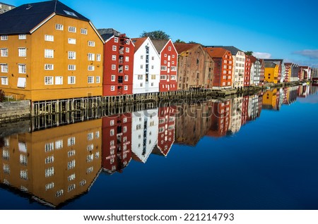 Famous wooden colored houses in Trondheim city in Norway, view from bridge - architecture background