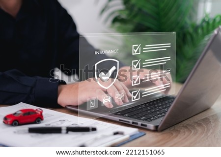 Car dealer businessman use laptop,checklist and signing car insurance on smart document. Modern car loan and insurance concepts on virtual screens without documents. Royalty-Free Stock Photo #2212151065