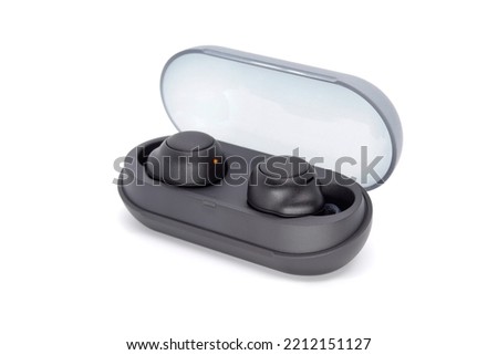Stylish wireless headphones with a charging container isolated on a white background