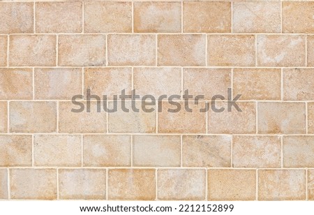 Wall made of smooth, rectangular yellow Sandstone blocks. Background image, texture Royalty-Free Stock Photo #2212152899