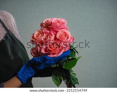 woman florist holding bouquet flowers rose