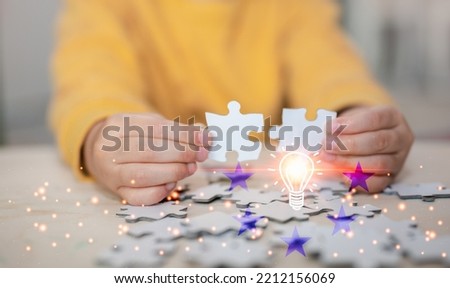 child development concept. the image of kids hands holding puzzles to connect together, the idea of enhance development for kids or children. 