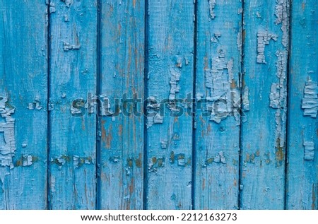 old wooden doors in turquoise with peeled paint with texture
