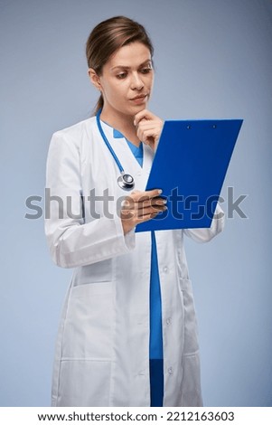 Doctor reading medical history on clipboard. isolated female portrait.