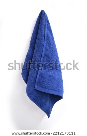 Blue Towel On A Towel Hook Against A White Wall Royalty-Free Stock Photo #2212173111