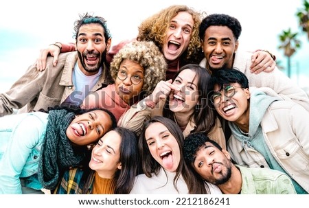 Multi cultural guys and girls taking best selfie outside on travel vacation - Happy life style friendship concept on urban international people having fun day together in Barcelona - Bright filter